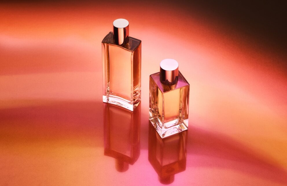 Picture of two bottles on orange and pink background