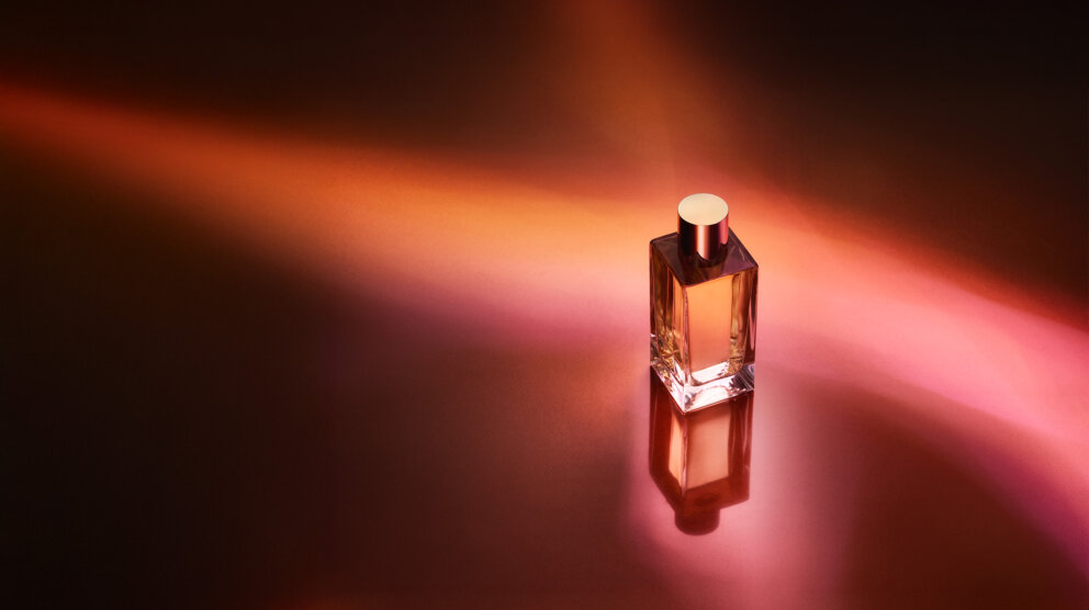 perfume bottles on red and orange background shot from the top